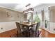 Well lit Dining Room offers Hardwood Floors, Neutral Colors, and a View of the Backyard at 119 Castlewood Rd, Tyrone, GA 30290