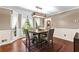 Light and airy dining room features hardwood floors, large windows, and a modern light fixture at 119 Castlewood Rd, Tyrone, GA 30290