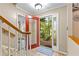 Bright entryway with red front door and tile flooring and stairs at 119 Castlewood Rd, Tyrone, GA 30290