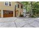 Two-story home featuring a garage, a driveway, and mature trees at 119 Castlewood Rd, Tyrone, GA 30290