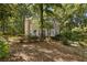 Two-story home with brick and siding exterior, surrounded by mature trees at 119 Castlewood Rd, Tyrone, GA 30290
