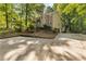 View of exterior and parking area showing mature trees and landscaping at 119 Castlewood Rd, Tyrone, GA 30290
