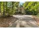 Beautiful home surrounded by lush greenery, showcasing a long driveway and serene setting at 119 Castlewood Rd, Tyrone, GA 30290