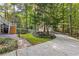 Exterior of house with a charming guest house, mature trees and lush landscaping at 119 Castlewood Rd, Tyrone, GA 30290