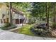 Exterior view of home with a charming deck, lush landscaping and a peaceful pond at 119 Castlewood Rd, Tyrone, GA 30290