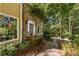 Exterior front door with decorative glass and brick walkway, surrounded by trees at 119 Castlewood Rd, Tyrone, GA 30290