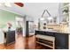 Spacious eat-in kitchen boasts hardwood floors, an island with bar seating, and stainless appliances at 119 Castlewood Rd, Tyrone, GA 30290