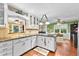 Bright kitchen with white cabinets, hardwood floors, granite countertops and seamless access to breakfast area at 119 Castlewood Rd, Tyrone, GA 30290