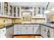 Traditional eat-in kitchen features white cabinetry, granite countertops, and tiled backsplash at 119 Castlewood Rd, Tyrone, GA 30290
