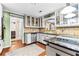 Bright eat-in kitchen with stainless steel appliances, hardwood floors, and glass front upper cabinets at 119 Castlewood Rd, Tyrone, GA 30290