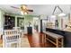 Open-concept kitchen and dining area with hardwood floors, stainless appliances, and island at 119 Castlewood Rd, Tyrone, GA 30290