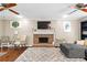 Living room with fireplace, hardwood floors, and modern decor at 119 Castlewood Rd, Tyrone, GA 30290