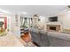 Open living room with fireplace, hardwood floors, and plenty of natural light at 119 Castlewood Rd, Tyrone, GA 30290