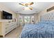 Comfortable main bedroom with ceiling fan, and natural light from bright windows at 119 Castlewood Rd, Tyrone, GA 30290