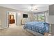 Spacious main bedroom featuring a ceiling fan, TV, and ensuite bath at 119 Castlewood Rd, Tyrone, GA 30290
