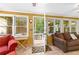 Cozy sunroom has lots of light and multiple seating options at 119 Castlewood Rd, Tyrone, GA 30290