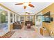 Sunroom is filled with natural light with dual ceiling fans and tile flooring at 119 Castlewood Rd, Tyrone, GA 30290