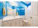 Bright blue bathroom featuring a white vanity, modern fixtures, and a shower over tub at 175 Robin Ct, Fayetteville, GA 30215