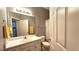 Bathroom with large mirror, sink, and shower, illuminated with a four-light fixture at 175 Robin Ct, Fayetteville, GA 30215