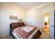 This bedroom is bright and has a large window and a view to an on-suite bathroom at 175 Robin Ct, Fayetteville, GA 30215