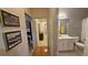 Hallway leading to bathroom with tile flooring, single sink vanity, and decor at 175 Robin Ct, Fayetteville, GA 30215