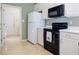 Kitchen with white cabinets, black appliances, and plenty of counter space at 175 Robin Ct, Fayetteville, GA 30215