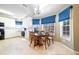 Eat-in kitchen featuring white cabinets, blue roman shades, and a dining table at 175 Robin Ct, Fayetteville, GA 30215