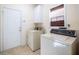 Functional laundry room with a washer, dryer, storage cabinet, and exterior door at 175 Robin Ct, Fayetteville, GA 30215
