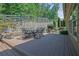 Backyard featuring outdoor dining, deck, and landscaped garden at 3320 Pleasant Springs Dr, Cumming, GA 30028