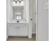 Well-lit bathroom with white vanity, mirror, and neutral color palette at 3320 Pleasant Springs Dr, Cumming, GA 30028