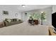 Large bonus room with a couch, desk, and lots of natural light at 3320 Pleasant Springs Dr, Cumming, GA 30028