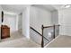 Upstairs hallway featuring wood railing and neutral carpeting at 3320 Pleasant Springs Dr, Cumming, GA 30028