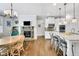 Open kitchen and dining area featuring granite counters, stainless appliances, bar seating and a stacked stone fireplace at 3320 Pleasant Springs Dr, Cumming, GA 30028