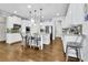 Spacious kitchen featuring white cabinets, granite countertops, stainless steel appliances and an island with bar seating at 3320 Pleasant Springs Dr, Cumming, GA 30028
