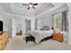Spacious main bedroom featuring tray ceiling, neutral carpet, and large windows for ample natural light at 3320 Pleasant Springs Dr, Cumming, GA 30028