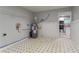 Unfinished basement featuring tile flooring, exposed pipes, a water heater, and access to another room at 3409 Hyland Dr, Decatur, GA 30032