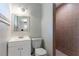 Well-lit bathroom with tile shower, tile flooring, a sink with a mirror, and a toilet at 3409 Hyland Dr, Decatur, GA 30032