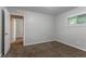 Carpeted bedroom features neutral walls, one window, and an open doorway to another room at 3409 Hyland Dr, Decatur, GA 30032