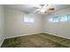 A modest bedroom featuring neutral walls, carpeted flooring, and bright natural light from two windows at 3409 Hyland Dr, Decatur, GA 30032