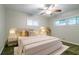 Staged bedroom with bed, side tables, carpet, and a large window at 3409 Hyland Dr, Decatur, GA 30032