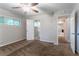 Neutral bedroom features carpet flooring, neutral walls, ceiling fan, bright windows, and an open doorway at 3409 Hyland Dr, Decatur, GA 30032