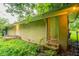 Side exterior featuring brick siding, and several doors, surrounded by lush ground cover at 3409 Hyland Dr, Decatur, GA 30032