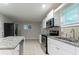 Renovated kitchen with stainless steel appliances, granite countertops, an island and a window at 3409 Hyland Dr, Decatur, GA 30032