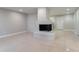 Clean open living area showcasing the tile floor and a unique whitewashed fireplace at 3409 Hyland Dr, Decatur, GA 30032