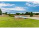 Wide view of the backyard showcasing a pristine inground pool and spacious grassy area at 4735 Widgeon Way, Cumming, GA 30028