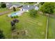 Expansive backyard features a private pool, lush lawn, and mature trees, perfect for outdoor enjoyment and relaxation at 4735 Widgeon Way, Cumming, GA 30028
