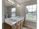 Bathroom featuring double sinks with new countertops and a large mirror, perfect for getting ready at 4735 Widgeon Way, Cumming, GA 30028