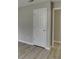 Neutral color door and baseboards with light wood flooring at 4735 Widgeon Way, Cumming, GA 30028