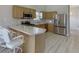 Kitchen with bar seating, stainless appliances, and light wood cabinetry at 4735 Widgeon Way, Cumming, GA 30028