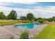 Backyard view of outdoor swimming pool surrounded by landscaping at 4735 Widgeon Way, Cumming, GA 30028
